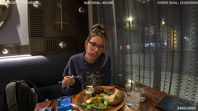 Waiter approaches streamer and tells her to keep it down a bit.