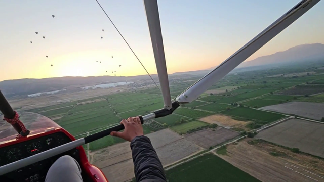Sunrise and hot air balloons from a glider