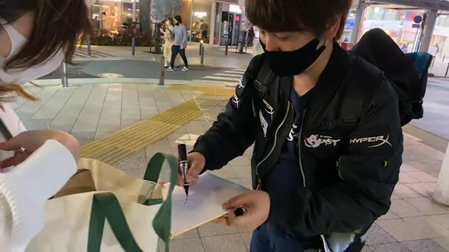 Chad Daigo gets a gift from a female fan