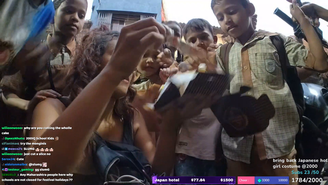 Justketh sharing a cake with slum kids in India