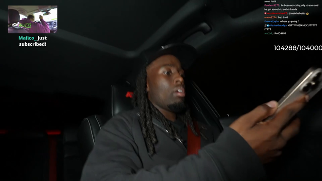 Kai Cenat looking at phone while driving