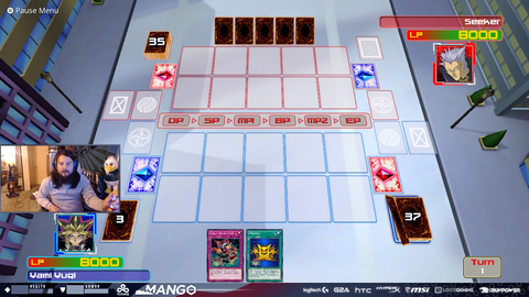 Mango plays a game of YuGiOh