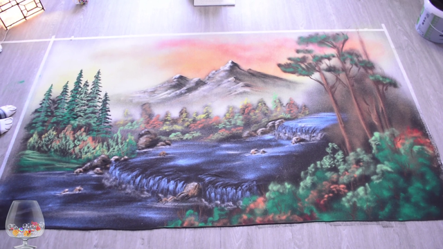 Sand artist destroys her impressive person-sized Bob Ross inspired sand painting