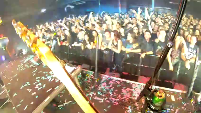 Herman Li sneaks through crowd to play Through The Flames on the venues bar