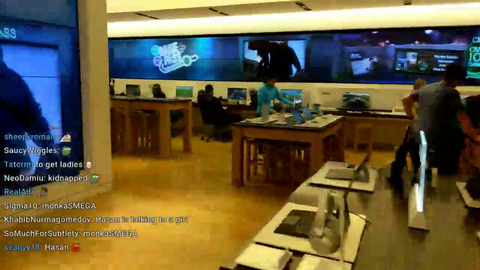Teen in pajamas plays Fortnite in Microsoft Store while his dad is buying a laptop