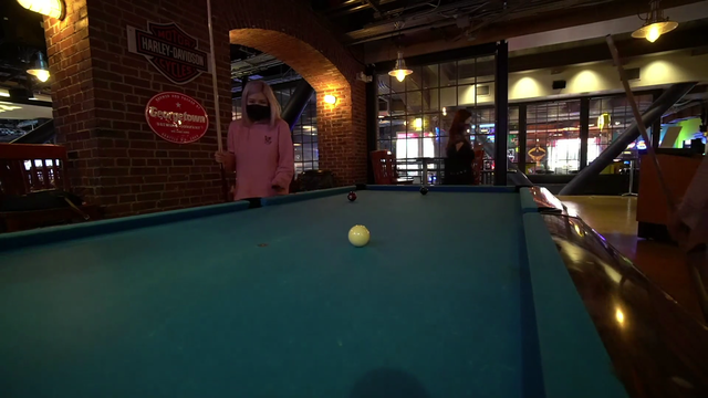 HAchubby attempts an important pool shot for her team