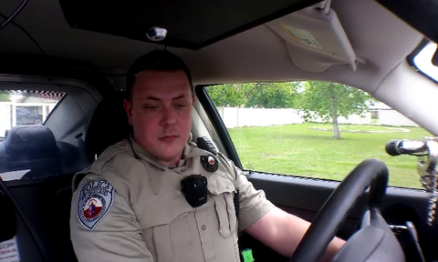NA cop does arm and tongue thing