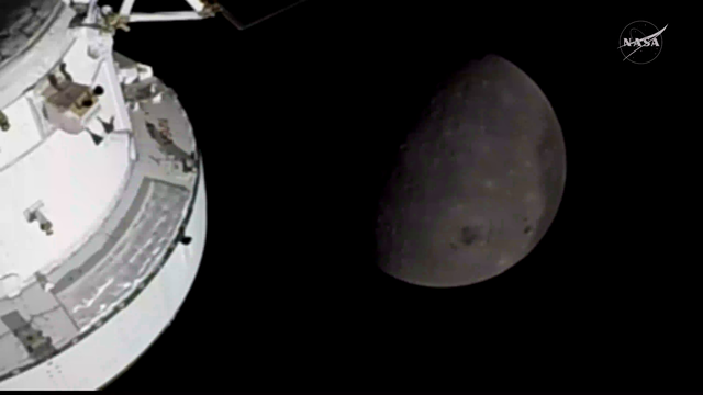 Astronaut shows a picture of the moon shot on IPhone