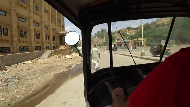 Little boy tries to hitch a quick rickshaw ride