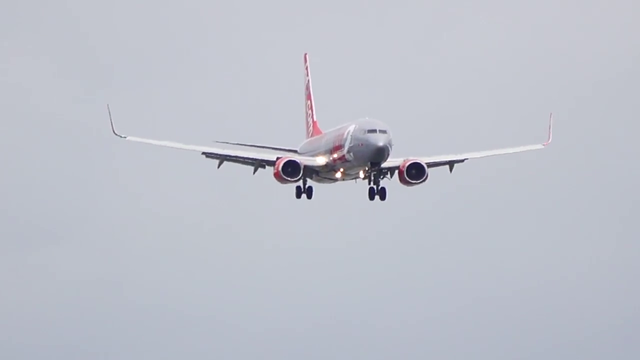 Boeing 737 aircraft blow-drying rain off Manchester Airport's runway on touchdown