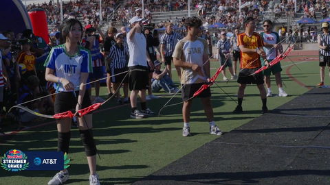 Some guy runs out in front of the archers during the archery event