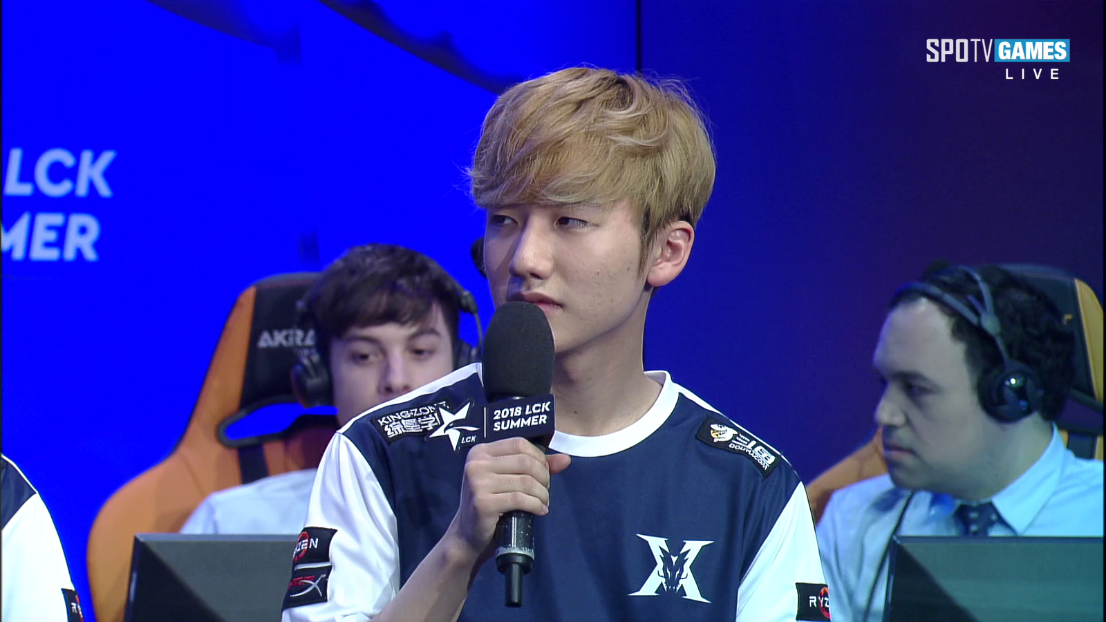Caster on the right pretends to be having a serious discussion (read the paper e's holding)