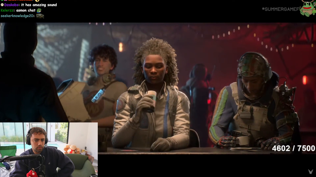 Miz checks Asmon's chat during the release date trailer for ARC Raiders