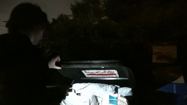 Homeless man hides in trashcan