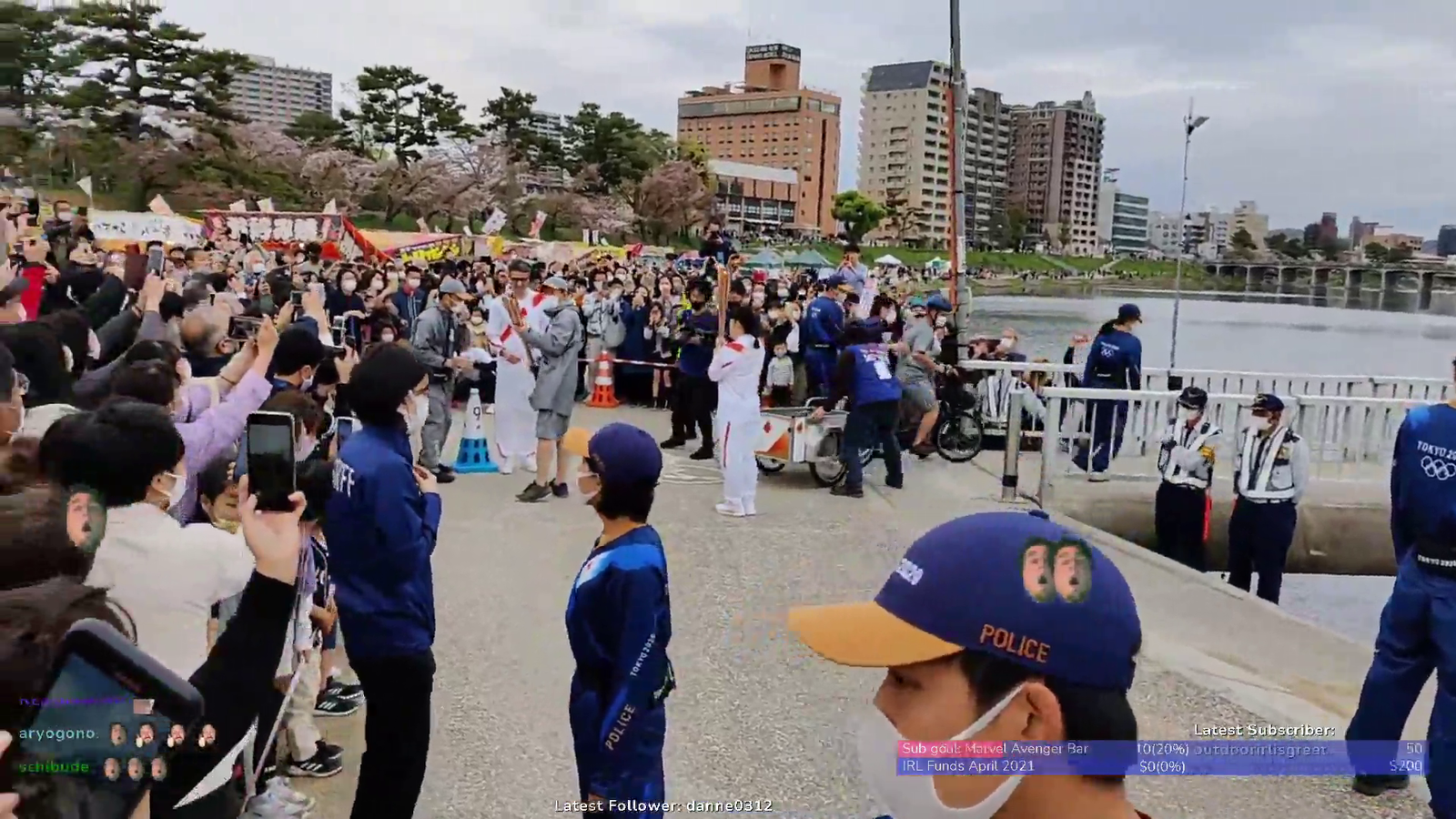 Tokyo 2020 Olympic torch being passed on.
