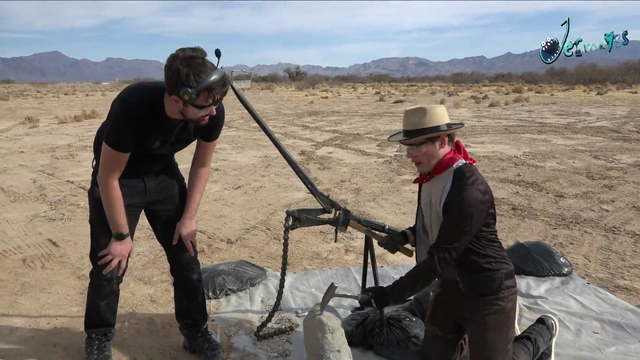 The wild Archaeologist demonstrates his hammer rock busting on a absolute huge rock.