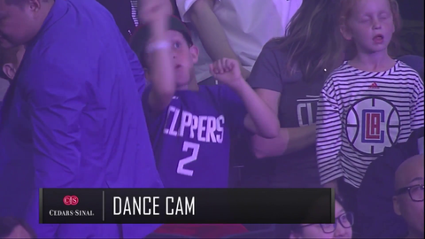 Kid baits NBA camera and flashes free Hong Kong shirt