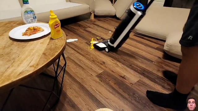 Erobb attempts to show off his new vacuum