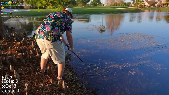 Jesse gets himself wet after hitting the golf ball that's stuck in the water