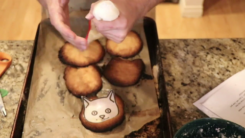 Henry frosts some nice cookies.