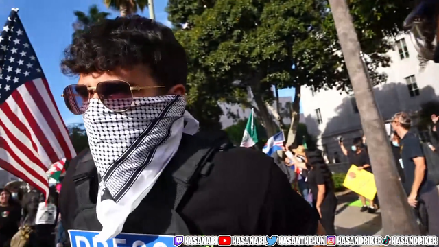 Rubber bullet (I think?) bounces off protestors hat next to Hasan @ LA No Kings protest