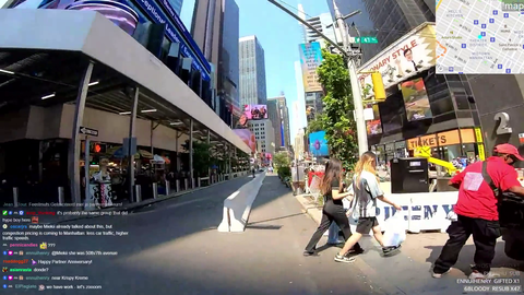 Emily driving around NYC in a bike with a selfie stick in hand.
