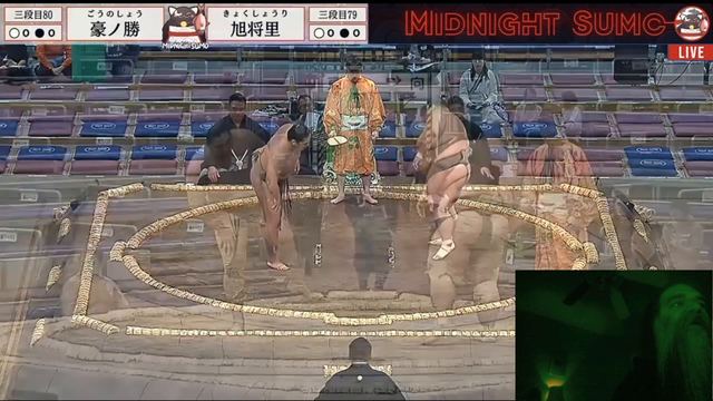 Aris sees something while watching Sumo wrestling