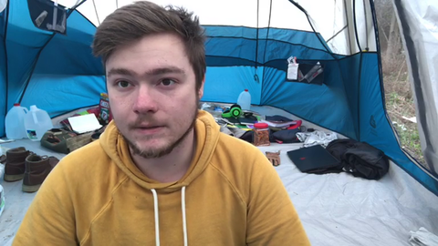 A homeless streamer streams from a tent in the woods