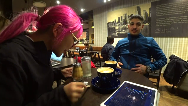 Eloise putting sugar in her coffee.