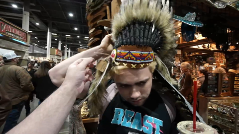 Mizkif tries on a hat at the Rodeo