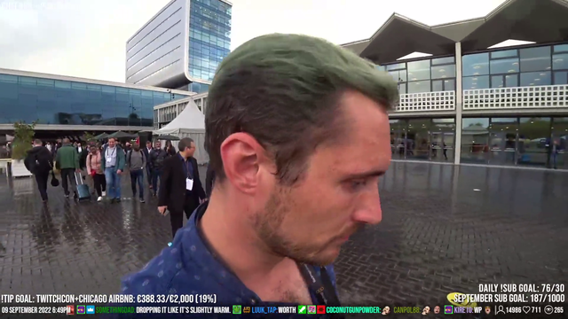 NPCs help streamer who has collected all the free stuff at tech convention