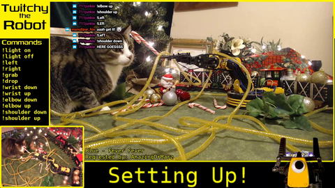 Twitch controlled robot arm feeding a cat a candy cane