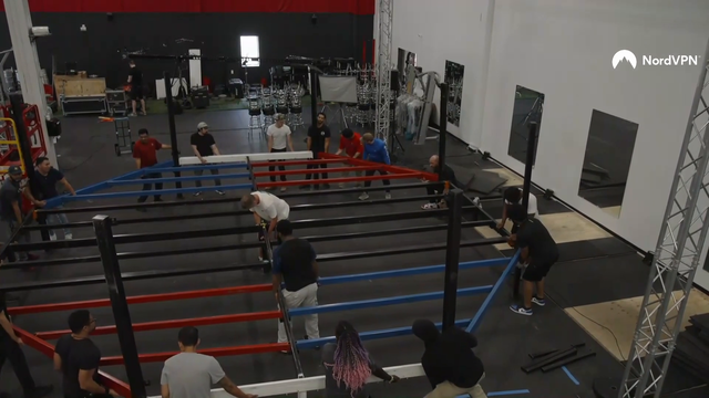 Production Team tears apart the Iron Forge Gym floor matting while setting up the MMA ring
