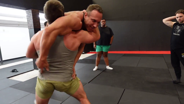 Knut gets lifted by a wrestler