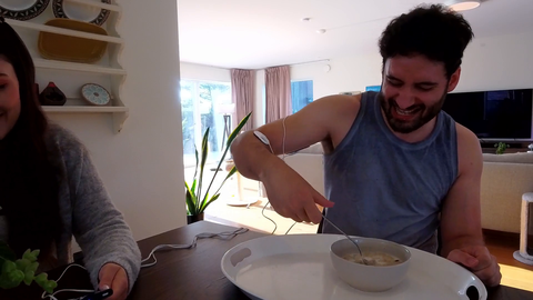 Evil woman laughs at man with Parkinsons struggling to eat