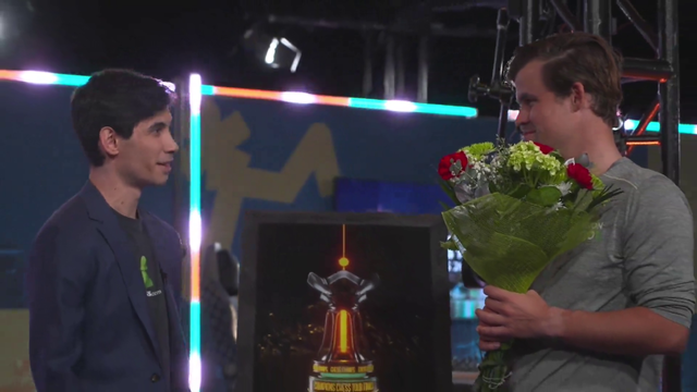 Champions chess tour finals winner Magnus Carlsen is awarded with a photo of a trophy.