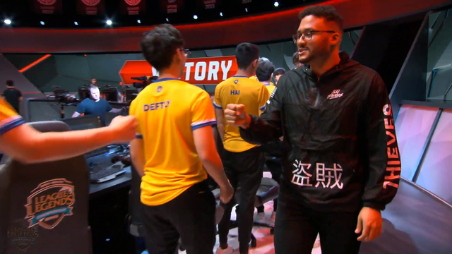 Pro league player heelies across stage after win