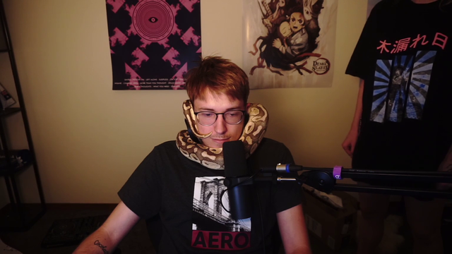 Streamer overcomes fear of sigma males by letting snake wrap around neck