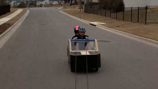 Arther built a soapbox and tests it on the road with Julia