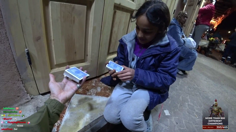 Joey teaching a kid how to do a card trick in Morocco