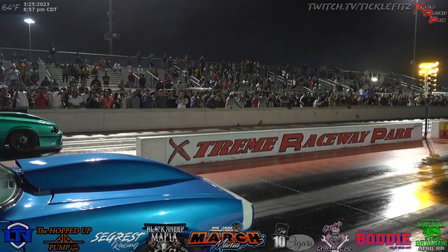 Racecar gets some air on the drag strip.