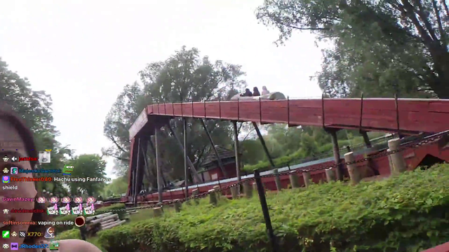 Two adults ride a water ride