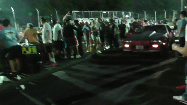 Dude almost gets ran over by a car during a drag racing event