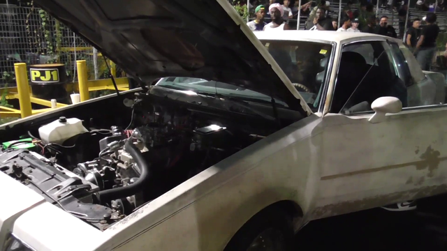 Drag racer at the "hood track" struggling to start his car forgets it's in gear