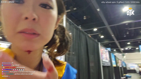 Emily takes a photo with a fan while bleeding