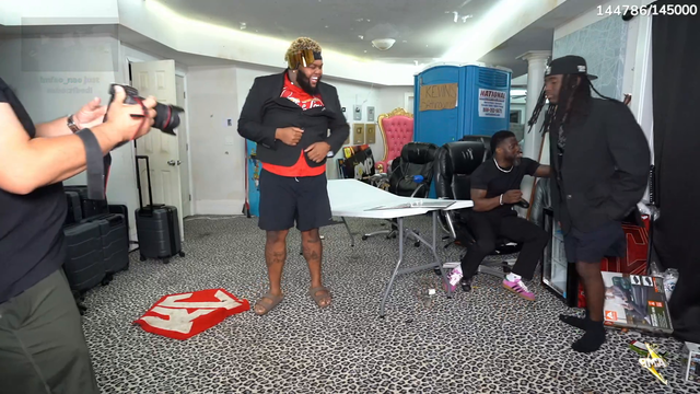Druski sits on the table for a pic w/ Kevin Hart and Kai Cenat