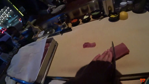 Fed gives the camera backpack to sushi chef