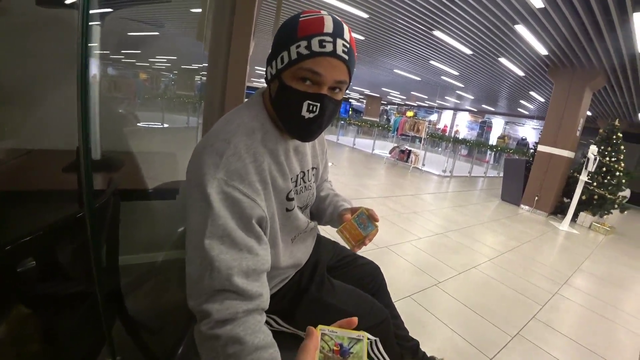 A kid at a mall pulls a pikachu pokemon card live on camera