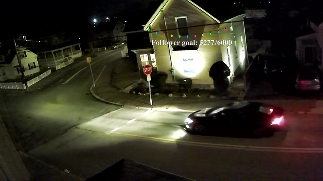 Guy stops at a stop sign and adds some flair to it