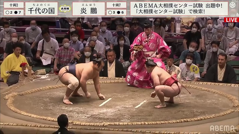 Smaller sumo wrestler defeats larger sumo wrestler using superior technique